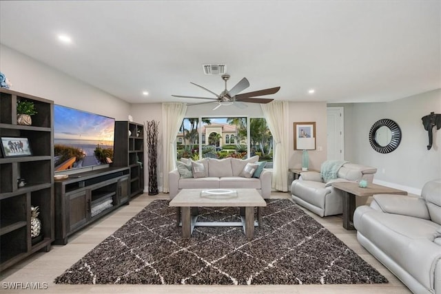 living room featuring ceiling fan and light wood-type flooring