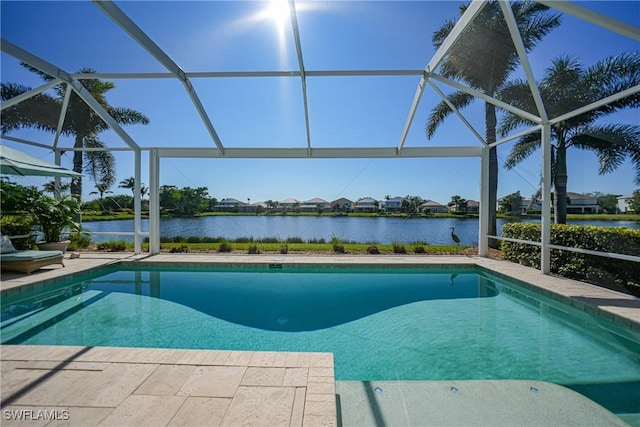 view of pool with a lanai, a water view, and a patio area