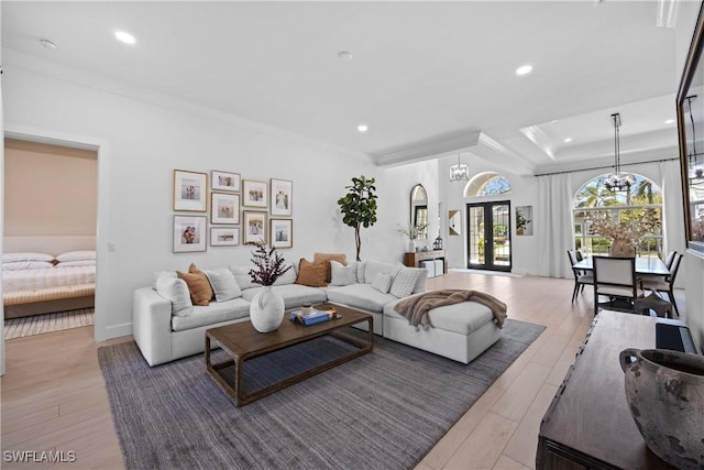 living room featuring french doors, ornamental molding, and hardwood / wood-style floors