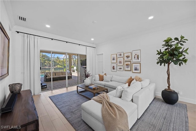 living room featuring light hardwood / wood-style flooring and ornamental molding