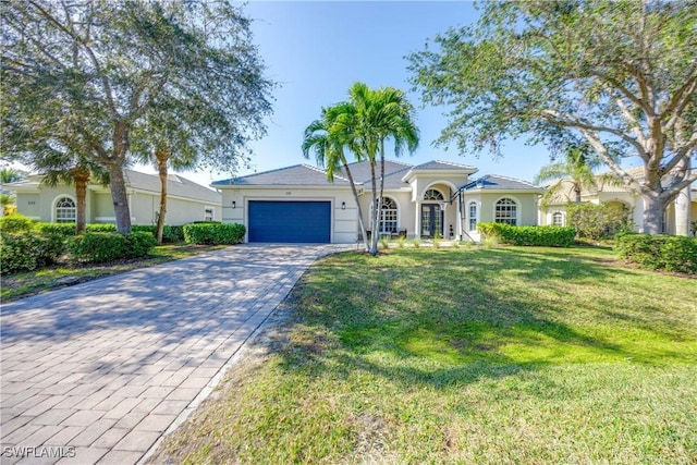 view of front of house with a front yard and a garage