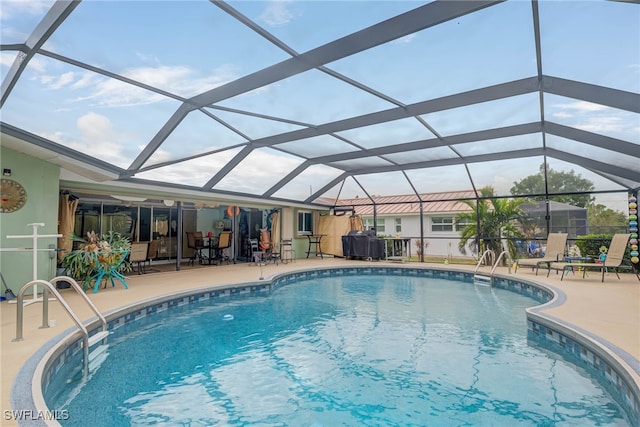 view of pool featuring a patio and glass enclosure