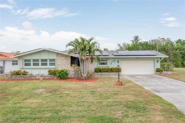 ranch-style home featuring a front lawn and a garage