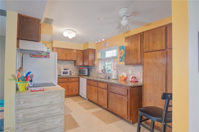 kitchen with white appliances, ceiling fan, tasteful backsplash, and sink