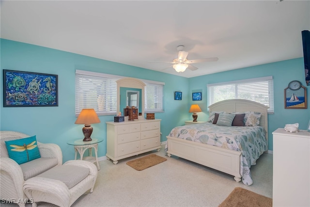 bedroom with ceiling fan and light colored carpet