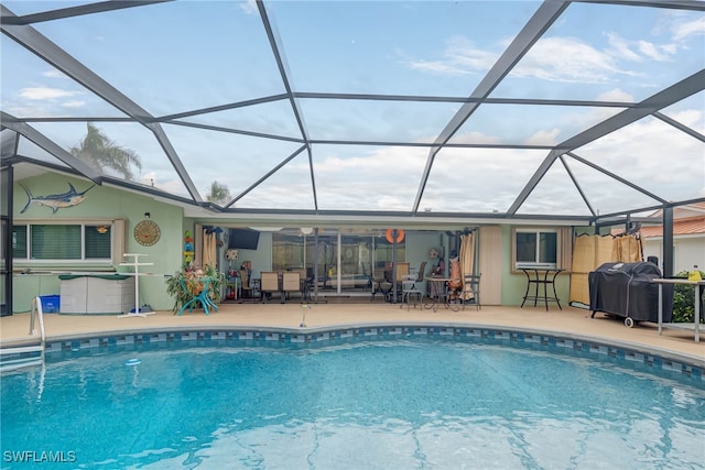 view of swimming pool with a lanai, a patio, and a grill