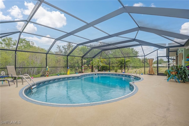 view of swimming pool with a lanai and a patio area