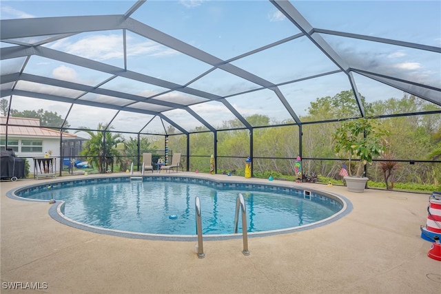 view of swimming pool with a lanai and a patio area