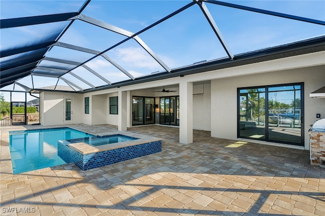 view of swimming pool with ceiling fan, glass enclosure, an in ground hot tub, and a patio