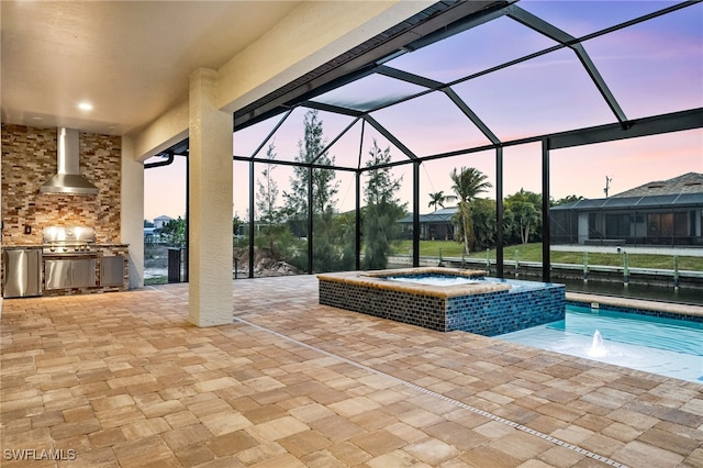 pool at dusk featuring a patio area, an in ground hot tub, area for grilling, grilling area, and a lanai