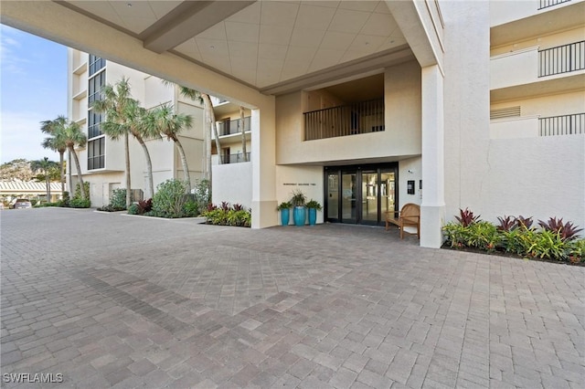 entrance to property featuring stucco siding