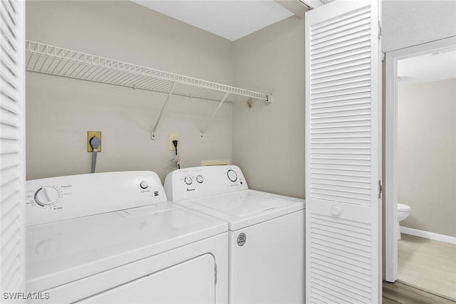 clothes washing area featuring separate washer and dryer and dark wood-type flooring