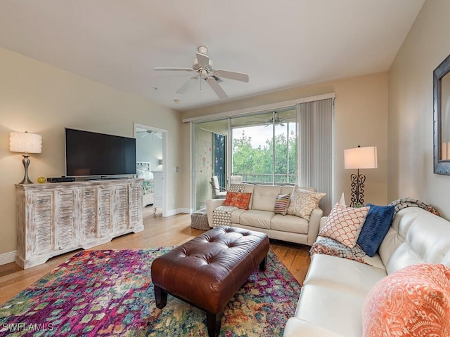 living room featuring ceiling fan and light hardwood / wood-style flooring