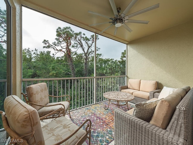 sunroom / solarium featuring ceiling fan