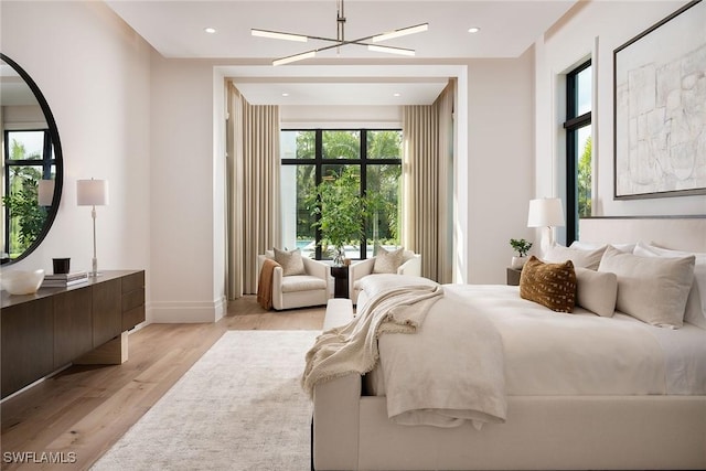 bedroom featuring light hardwood / wood-style floors and a notable chandelier