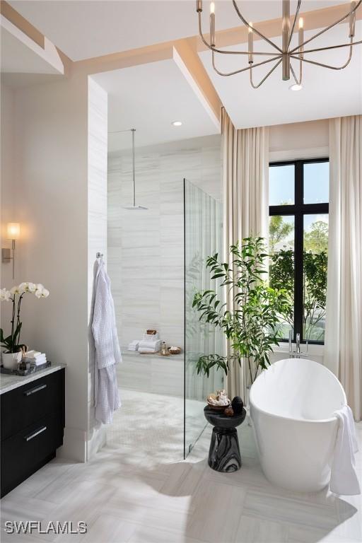 bathroom featuring separate shower and tub, french doors, vanity, and a chandelier