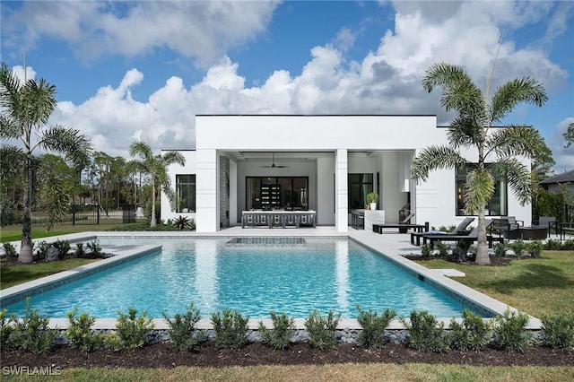 view of swimming pool featuring a lawn and ceiling fan