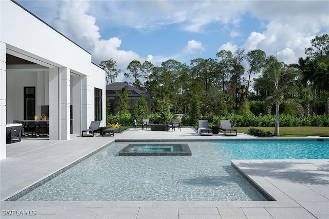 view of swimming pool featuring a patio and an in ground hot tub