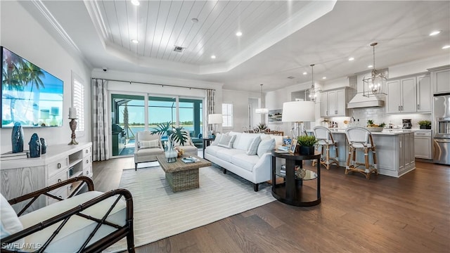 living room with dark hardwood / wood-style floors, a raised ceiling, wood ceiling, and crown molding