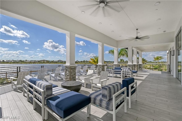 view of patio / terrace featuring ceiling fan and a water view