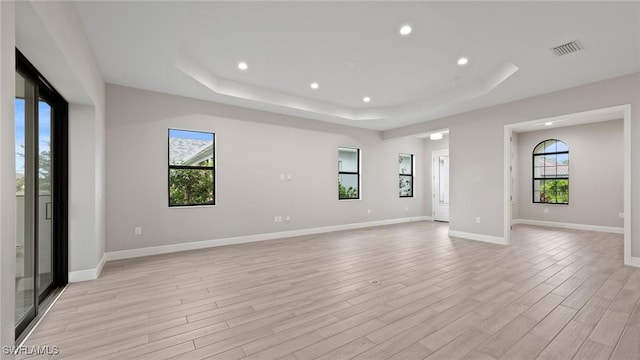 4075 Pegasus Way, Naples, FL 34120 - empty room with a tray ceiling, recessed lighting, light wood-type flooring, and baseboards