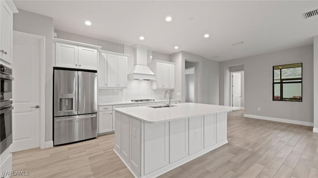 4075 Pegasus Way, Naples, FL 34120 - kitchen with stainless steel appliances, custom range hood, a sink, an island with sink, and backsplash