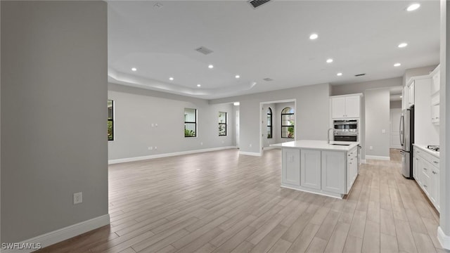 4075 Pegasus Way, Naples, FL 34120 - kitchen featuring appliances with stainless steel finishes, light countertops, recessed lighting, light wood-style flooring, and open floor plan