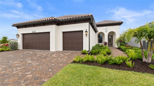4075 Pegasus Way, Naples, FL 34120 - mediterranean / spanish home with decorative driveway, a garage, stucco siding, and a tiled roof
