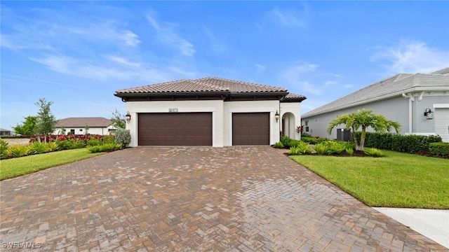 4075 Pegasus Way, Naples, FL 34120 - mediterranean / spanish-style house with a front yard, a tiled roof, decorative driveway, a garage, and stucco siding