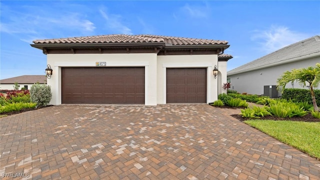 4075 Pegasus Way, Naples, FL 34120 - view of front facade with decorative driveway, a tile roof, an attached garage, and stucco siding