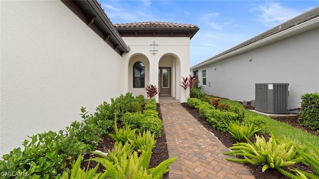 4075 Pegasus Way, Naples, FL 34120 - property entrance with central air condition unit and stucco siding