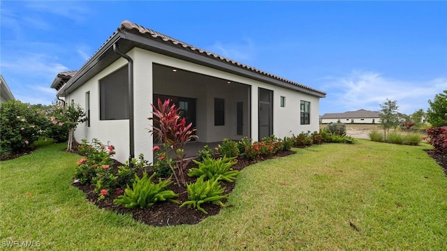 4075 Pegasus Way, Naples, FL 34120 - back of property featuring a yard, stucco siding, and a tiled roof