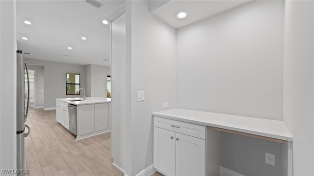 4075 Pegasus Way, Naples, FL 34120 - corridor with a sink, recessed lighting, light wood-style floors, and baseboards