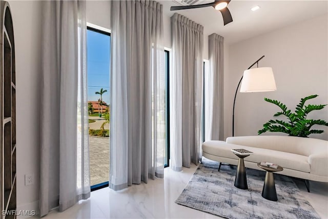 sitting room featuring ceiling fan