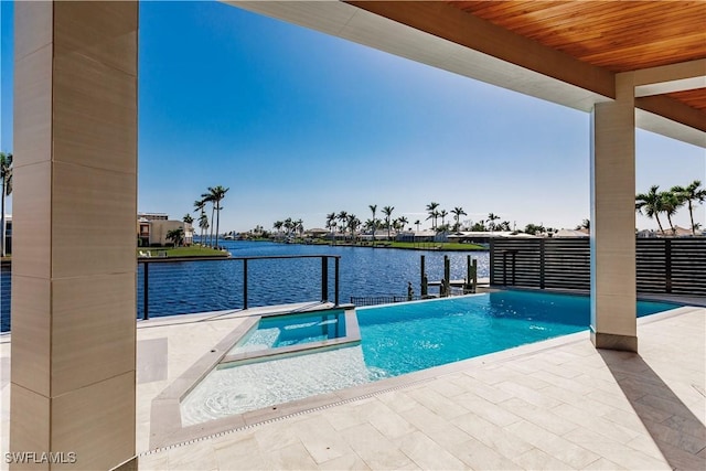 view of pool featuring a patio, a water view, and an in ground hot tub