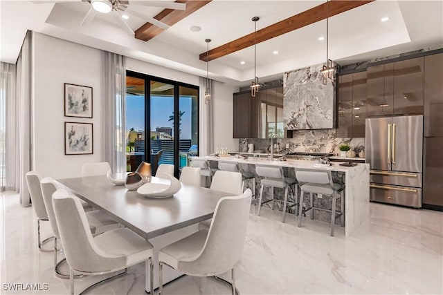 dining area featuring beamed ceiling and ceiling fan