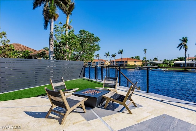 view of patio featuring a fire pit and a water view