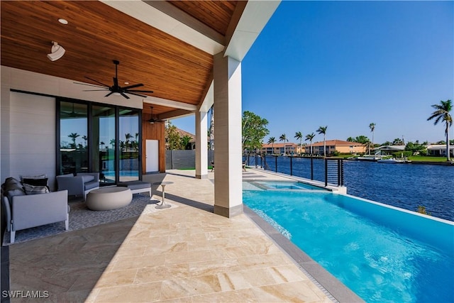 view of pool featuring a patio, a water view, and ceiling fan