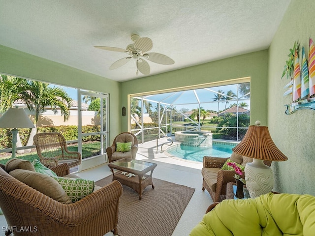 sunroom featuring ceiling fan and a swimming pool