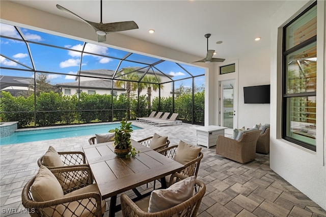 view of patio with ceiling fan, a lanai, and an outdoor hangout area