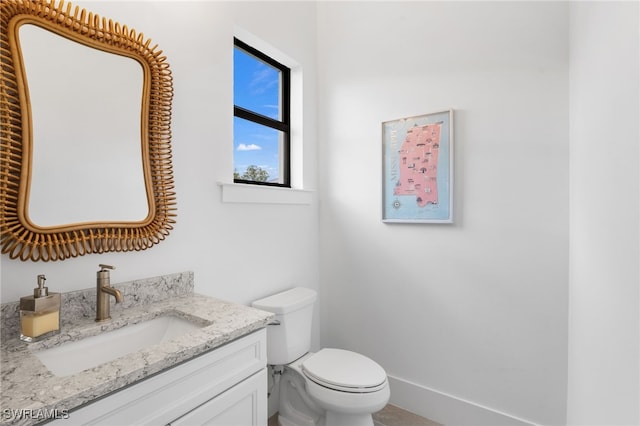 bathroom with toilet and vanity