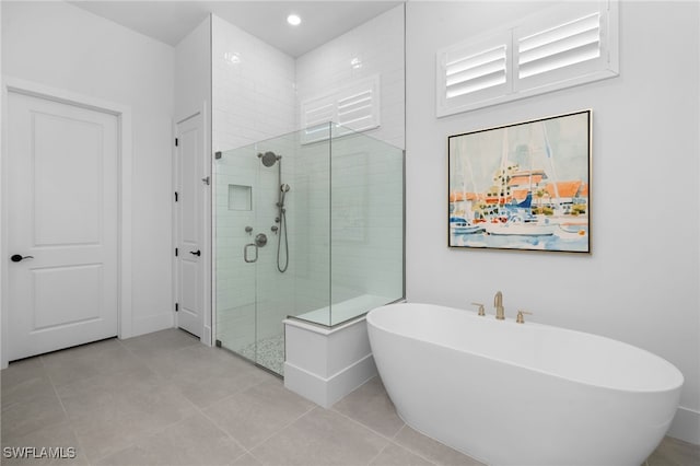 bathroom featuring tile patterned floors and shower with separate bathtub