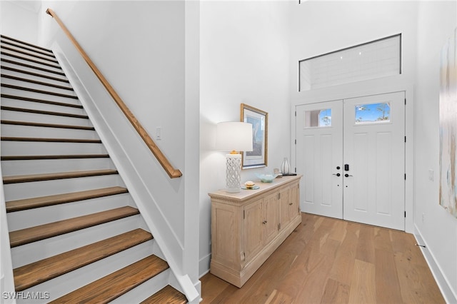 foyer entrance with light hardwood / wood-style floors