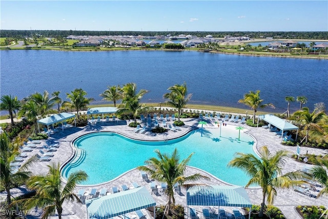 view of swimming pool with a patio and a water view