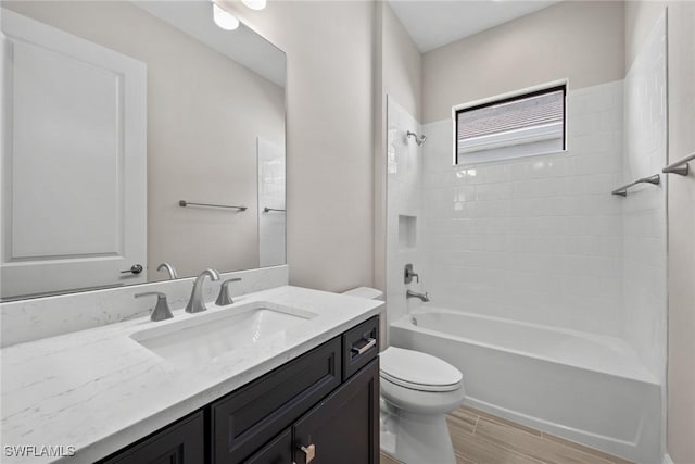 full bathroom featuring vanity, toilet, and tiled shower / bath