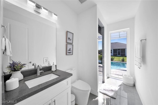 bathroom featuring vanity and toilet