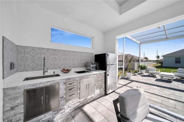 view of patio featuring sink and an outdoor kitchen