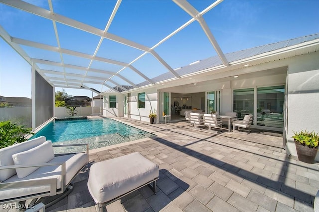 view of swimming pool with an outdoor hangout area, glass enclosure, and a patio area