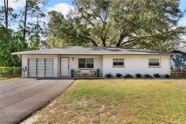 ranch-style home with covered porch and a front yard