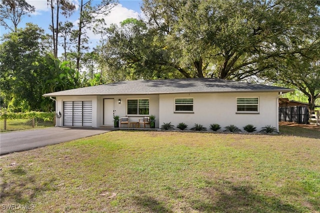 ranch-style house featuring a front lawn and a garage